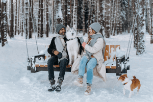 Owners with dogs in the Winter practicing pet safety