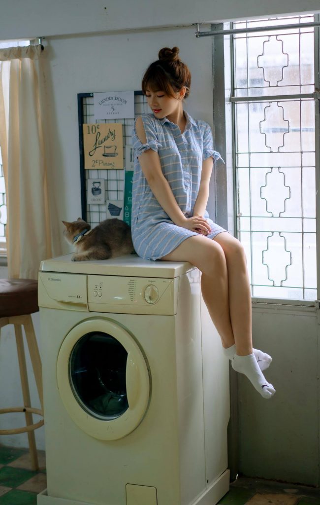 cat following woman into laundry room