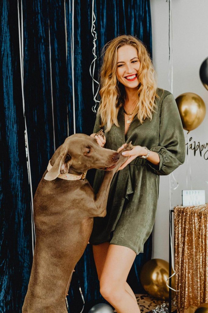 a woman dances with a dog at a new years party